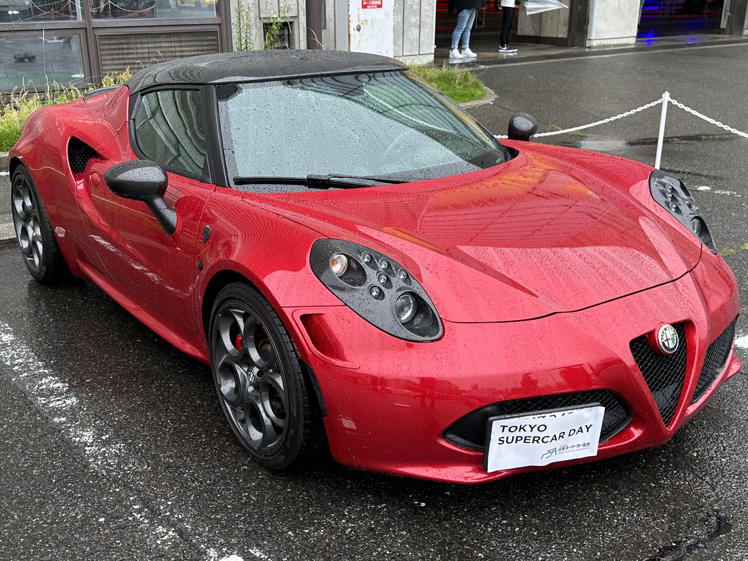 Red Alfa Romeo 4C coupe at a car gathering